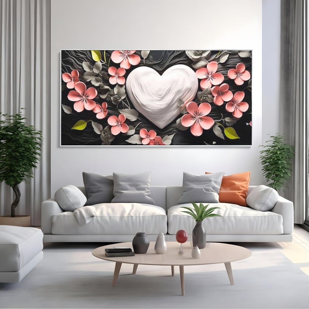 Tablou canvas cu tablou canvas cu inima alba si flori roz, in rama de aluminiu argintiu, pe perete intr-un living